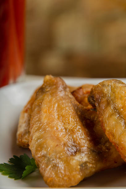 istock Fresh fried chicken wings on a white plate 1269752051