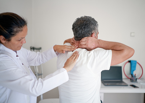 Man having chiropractic back adjustment. Osteopathy, Physiotherapy, Injury rehabilitation concept