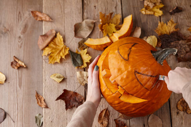 istock Cutting scary pumpkin jack for Halloween 1269754430