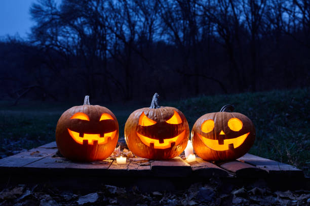 istock Halloween pumpkins burning in forest at night 1269754494