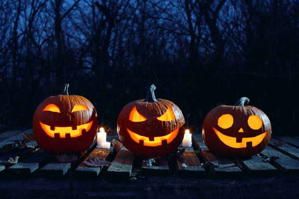 istock Halloween pumpkins burning in forest at night 1269754498