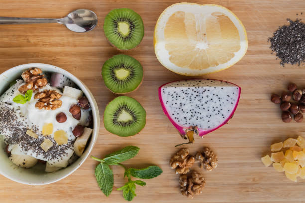 istock Fruit salad and its ingredients set on a wooden board 1269754574