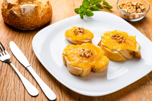 istock Brie cheese bruschetta with apricot jam and walnuts 1269757222