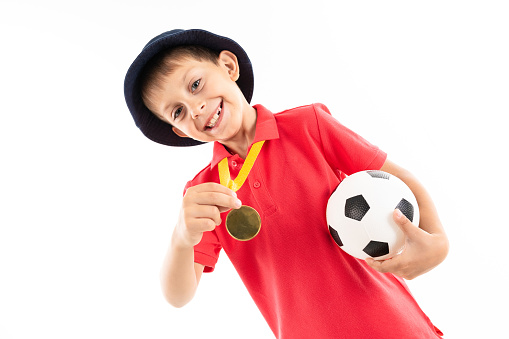 Caucasian teenager boy winner of soccer competition, picture isolated on white background.