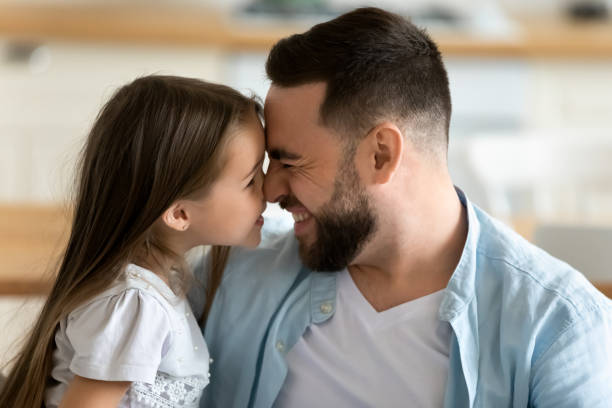 istock Close up young handsome father happily touch noses with daughter. 1269761464