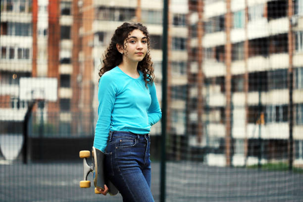 istock Girl holding a skateboard 1269761639