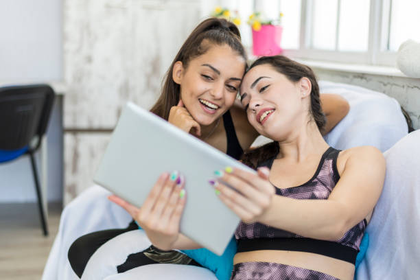 istock Two girlfriends are having fun on the net in sportswear. 1269763342