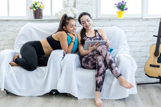 istock Two girlfriends are having fun on the net in sportswear. 1269763349