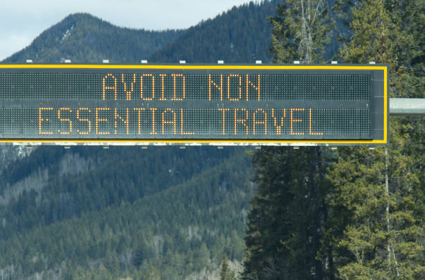 View of sign on Trans-Canada Highway "Avoid non-essential travel" stock photo