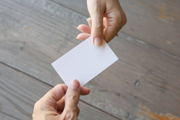 istock Hand holding Business card on a wood background 1269770408