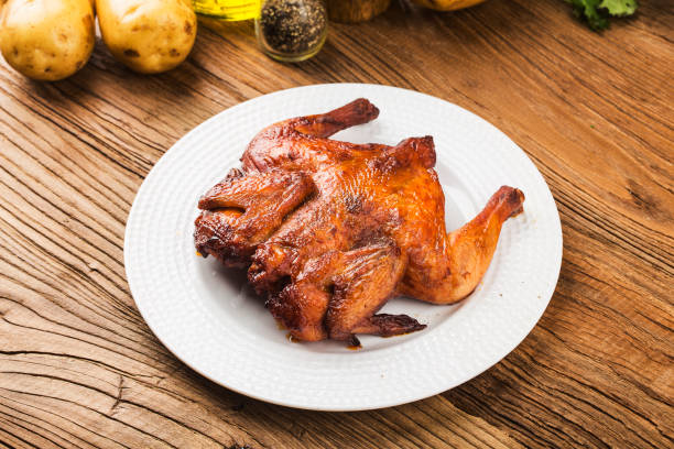 istock Fresh roast chicken on a wooden board background 1269777064