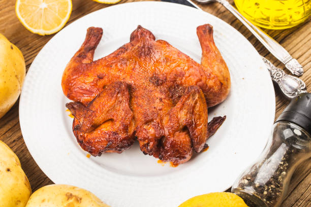 istock Fresh roast chicken on a wooden board background 1269777074