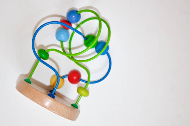 istock multicolored children's toy isolated on white background. Developing logistic toy Labyrinth with beads. 1269785077