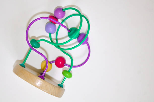 istock multicolored children's toy isolated on white background. Developing logistic toy Labyrinth with beads. 1269785094