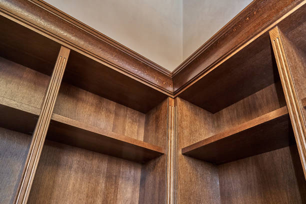 istock Wooden bookcase with empty shelves in home library 1269786992