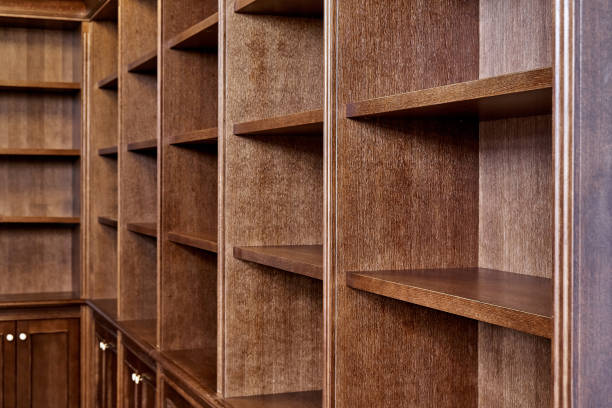istock Wooden bookcase with empty shelves in home library 1269787075