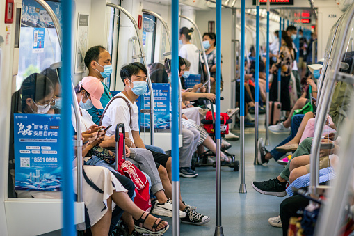 Wuhan China , 29 August 2020 : Chinese people wearing surgical face masks inside the Wuhan subway carriage in Wuhan Hubei China