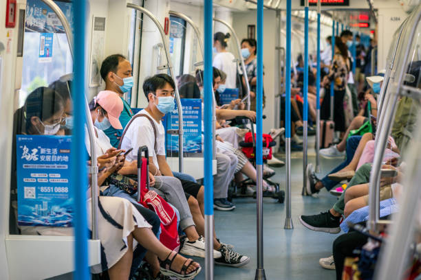 chinese people wearing surgical face masks inside the wuhan subway carriage in wuhan hubei china - china covid imagens e fotografias de stock
