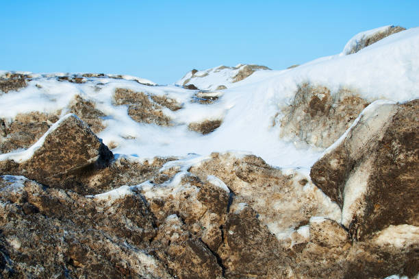 melting blocks of snow during the afternoon, against the blue sky. winter landscape. - dirty pass imagens e fotografias de stock