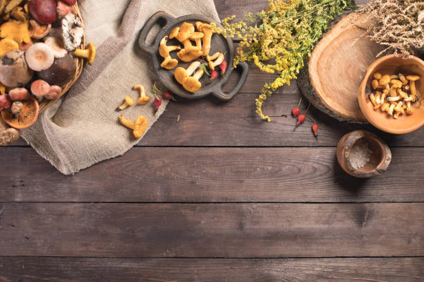 Autumn harvest of mushrooms on vintage rustic wooden background. Rustic kitchen table. Flat lay top, top view . Layout with free text space. Forest harvest concept. stock photo