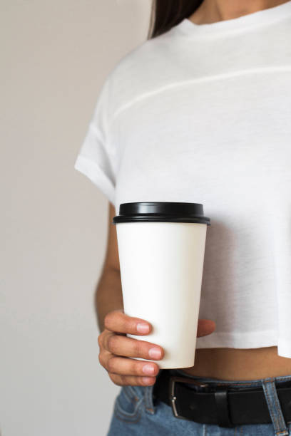 istock a disposable coffee cup in young womans hand 1269790090