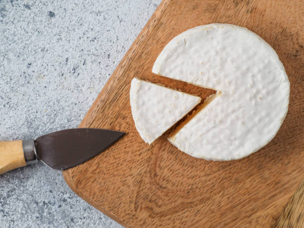 istock Traditional french cheese brie on wodden cutting board. 1269791137