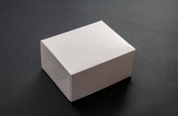 Closed white package box, blank advertise template for products packaging, on black background.