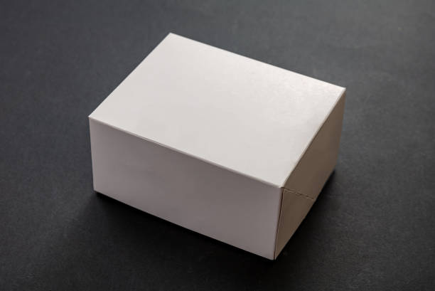 istock Closed white package box, blank advertise template for products packaging, on black background. 1269792786