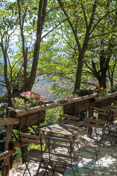 wooden chairs, tables, mountain nature background. - greece blue forest national landmark imagens e fotografias de stock