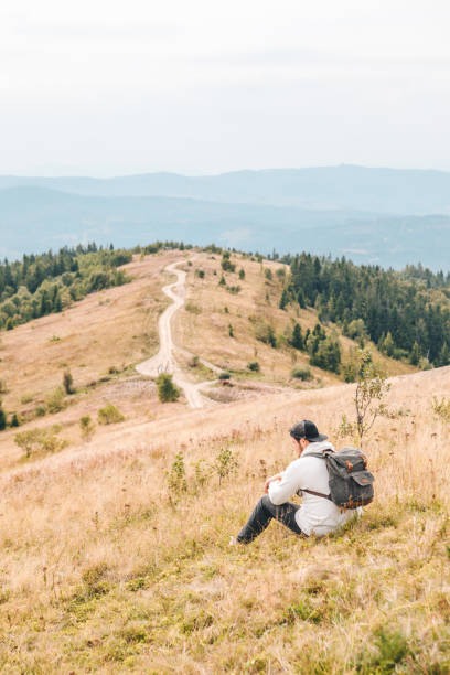 istock man with backpack hiking by autumn mountains 1269793415