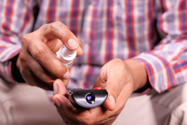 istock Cleaning Tv remote control with sanitizer spray 1269795412