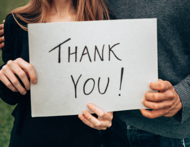 istock couple holding a board say thank you 1269795575
