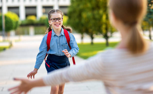 istock Mother meeting daughter from school 1269796722