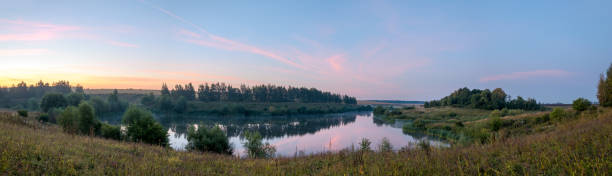 istock Panoramic view of calm lake during sunrise. 1269796967