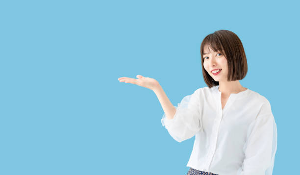 istock Young asian woman pointing at copy space. 1269798880