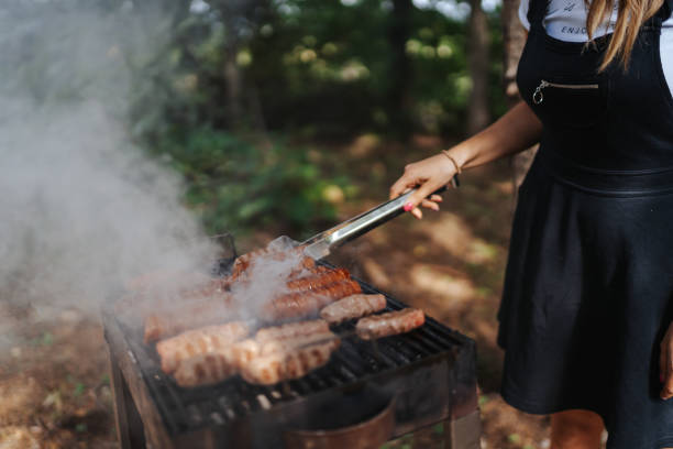 istock Smiling woman preparing barbecue at backyard 1269798888