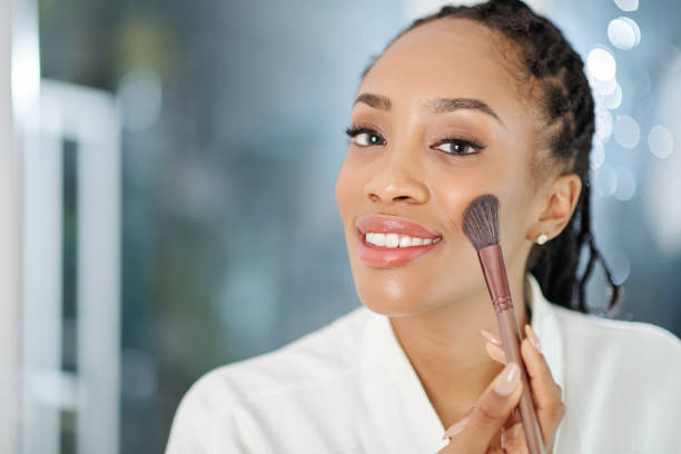 istock Woman applying peach blush 1269798982