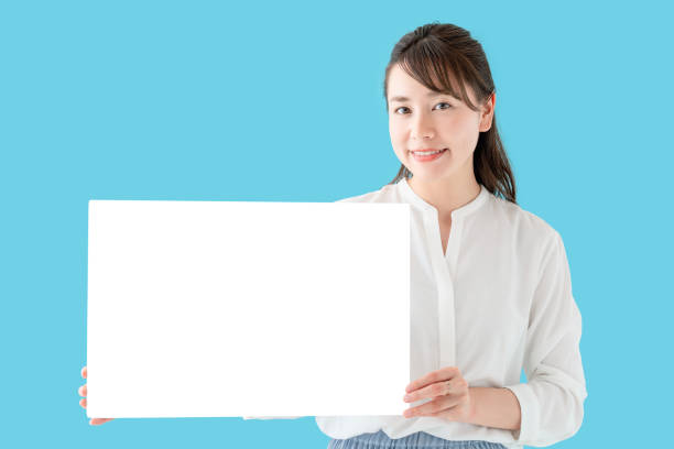 istock Young businesswoman holding a sign board. 1269799227