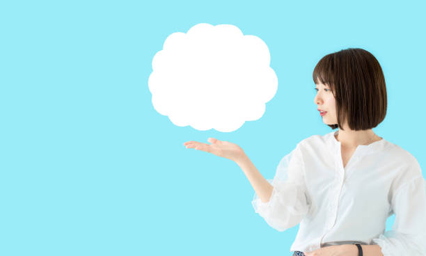 istock Young asian woman showing a speech bubble. 1269799277