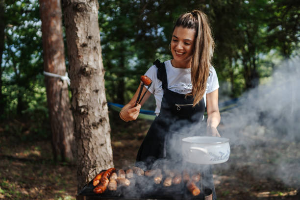 istock Smiling woman preparing barbecue at backyard 1269799440