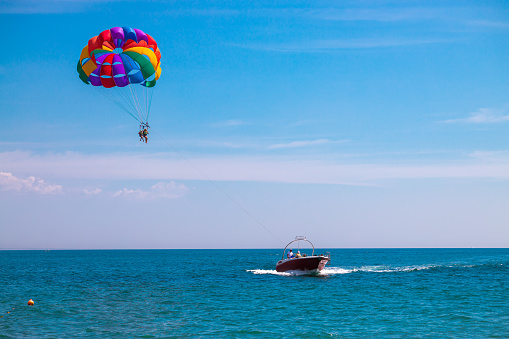 Kemer, Turkey - January 8, 2023: Tourists playing flyboard, a hydroflighting device which supplies propulsion to drive the Flyboard into the air to perform a sport known as hydroflying.