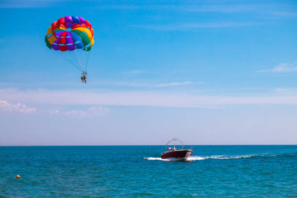 Parasailing boat ride. Extreme fun activity on the sea for people Parasailing boat ride. Extreme fun activity on the sea for people parasailing stock pictures, royalty-free photos & images