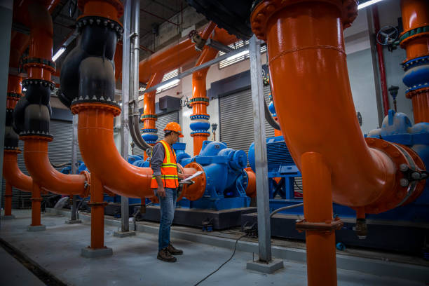 engineer under checking the industry cooling tower air conditioner is water cooling tower air chiller HVAC of large industrial building to control air system.