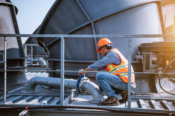 istock engineer under checking the industry cooling tower air conditioner is water cooling tower air chiller HVAC of large industrial building to control air system. 1269801226