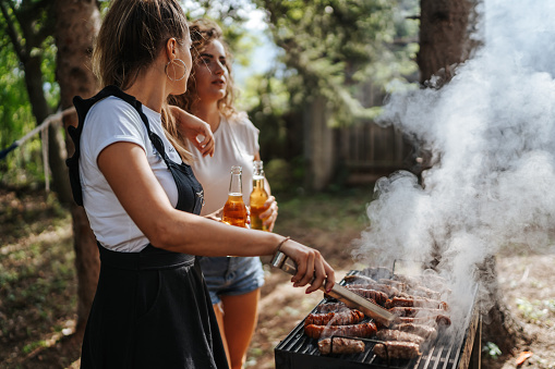Two female friends enjoying barbecue party