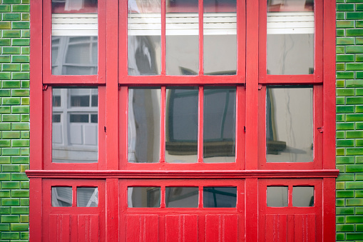 3D render of red open shining door on red wall background