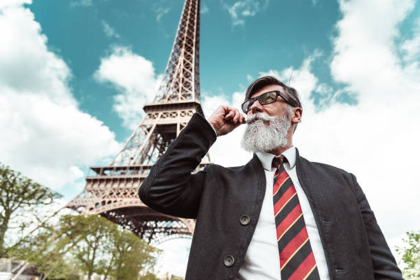 istock caucasian hipster man under the tour eiffel 1269806272