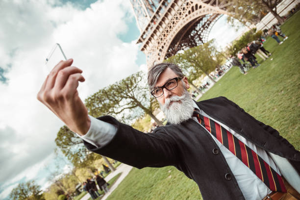 istock caucasian hipster man under the tour eiffel 1269806457