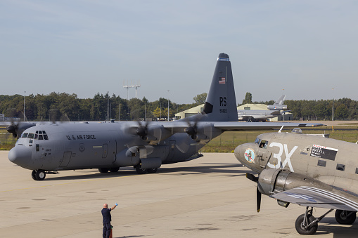 Beja, Portugal: Embraer C-390 / KC-390 Millennium on the runway - medium-size, twin-engine, jet-powered military transport aircraft produced by the Brazilian aerospace manufacturer Embraer - Brazilian and Portuguese flags - Air Base No. 11 - Base Aérea Nº 11, BA11.