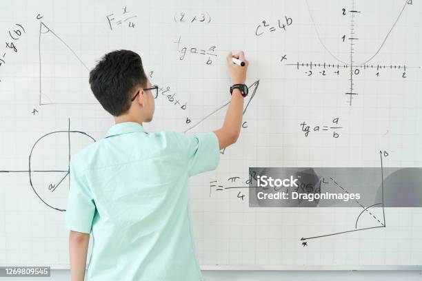 Schoolboy Writing Geometry Equation Stock Photo - Download Image Now - Mathematics, Mathematical Symbol, Whiteboard - Visual Aid